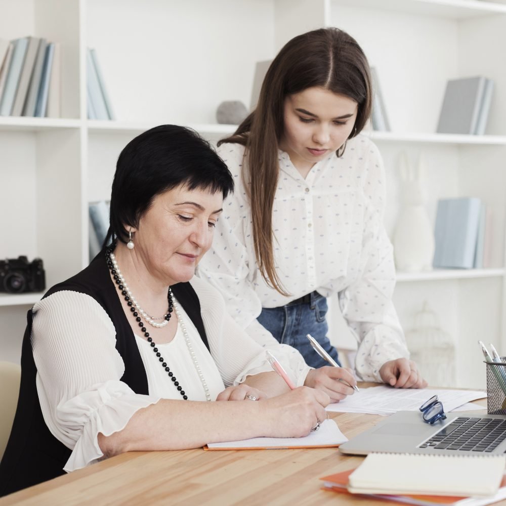 mother-daughter-writing-using-laptop